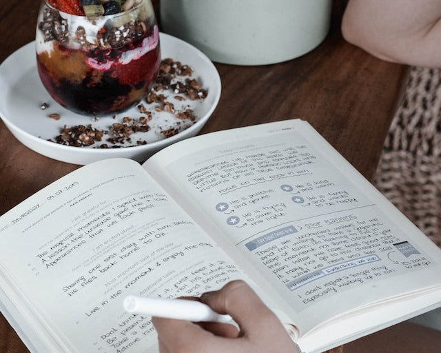 Person writing in food journal
