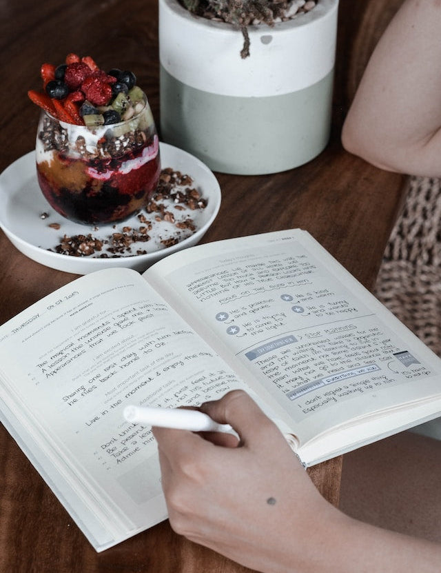 Person writing in food journal