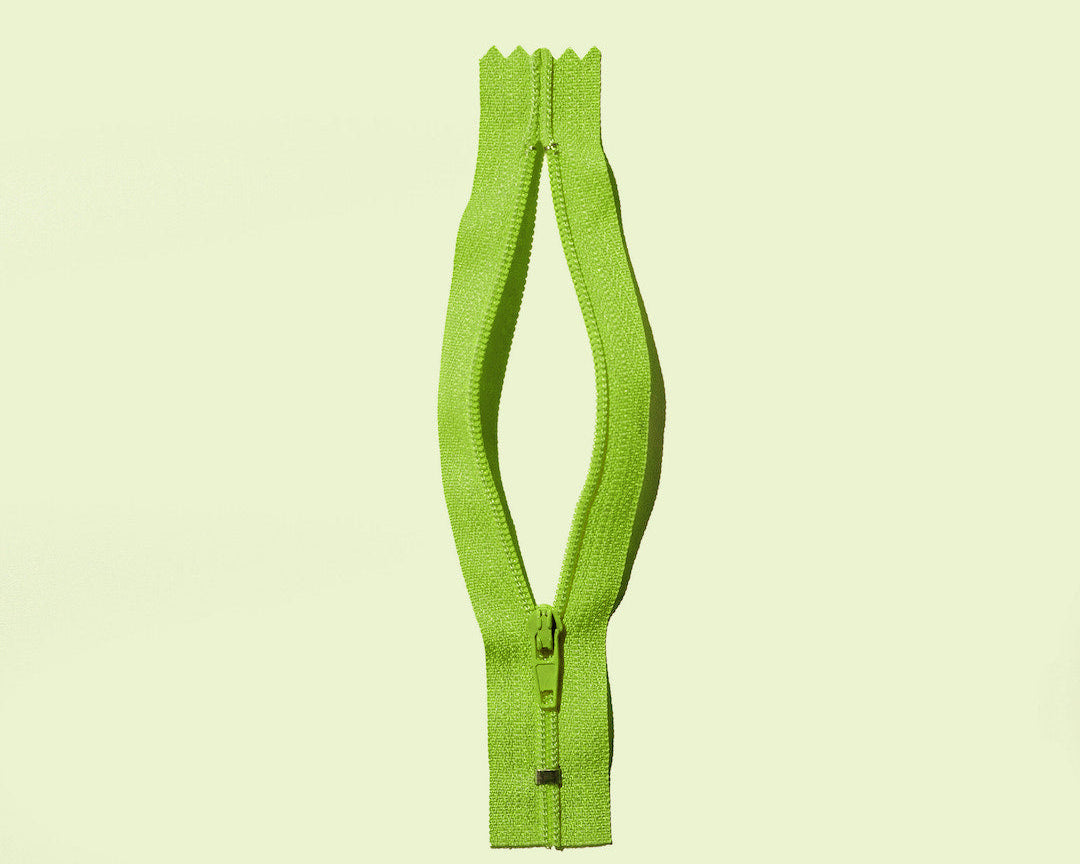 An open zipper to suggest the female genitalia