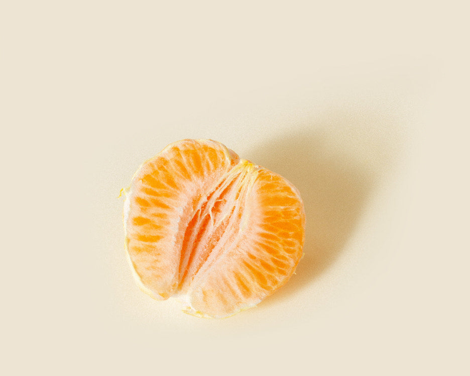 half of an orange, meant to represent the female genitalia