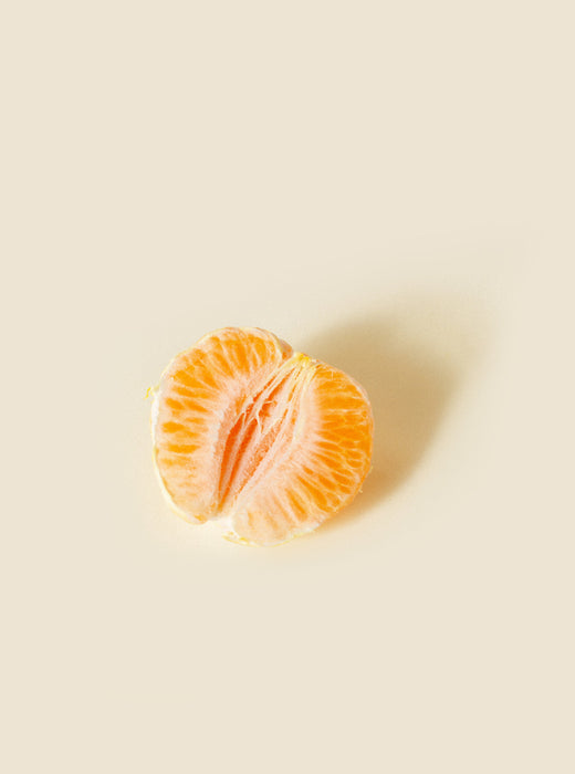 half of an orange, meant to represent the female genitalia