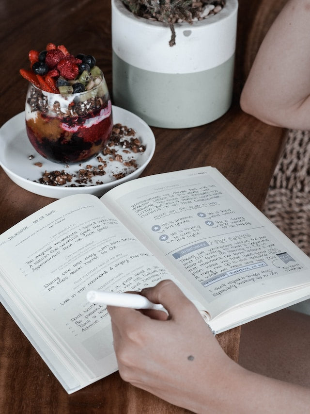 Person writing in food journal