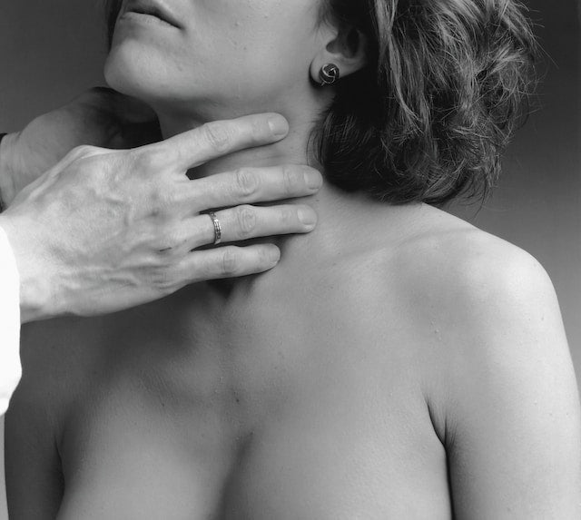 a woman's thyroid being examined