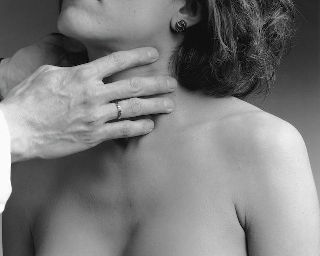 a woman's thyroid being examined