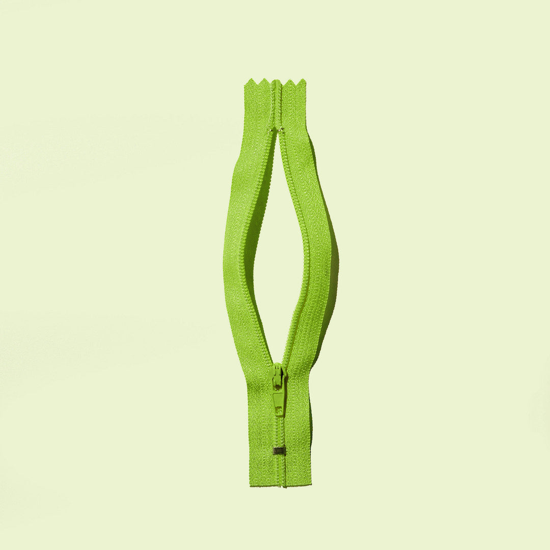 An open zipper to suggest the female genitalia 