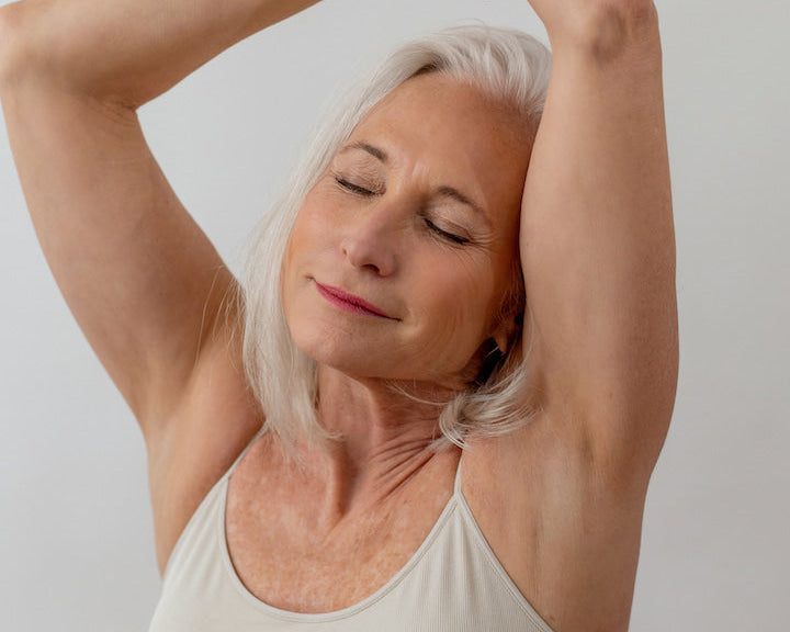Woman with arms raised over her head