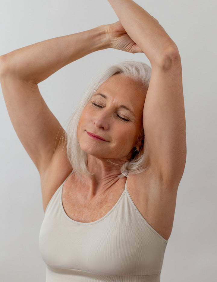 Woman with arms raised over her head