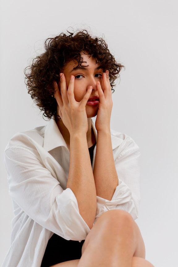 Woman with her face in her hands