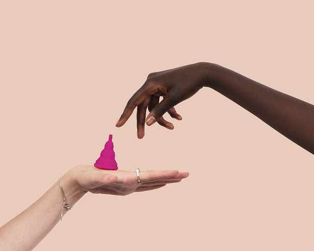 hand reaching for menstrual cup