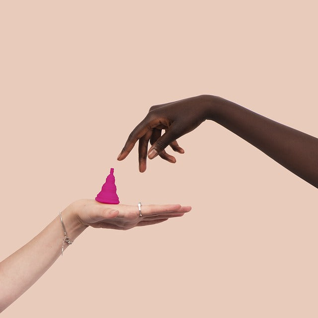 hand reaching for menstrual cup