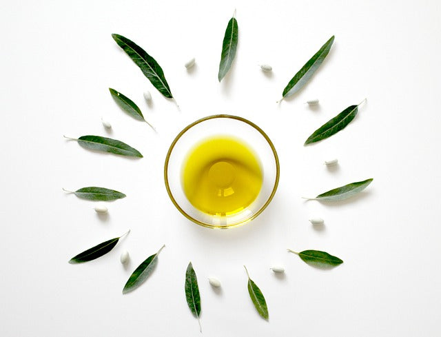 Tea Tree Oil in bowl with leaves spread around it