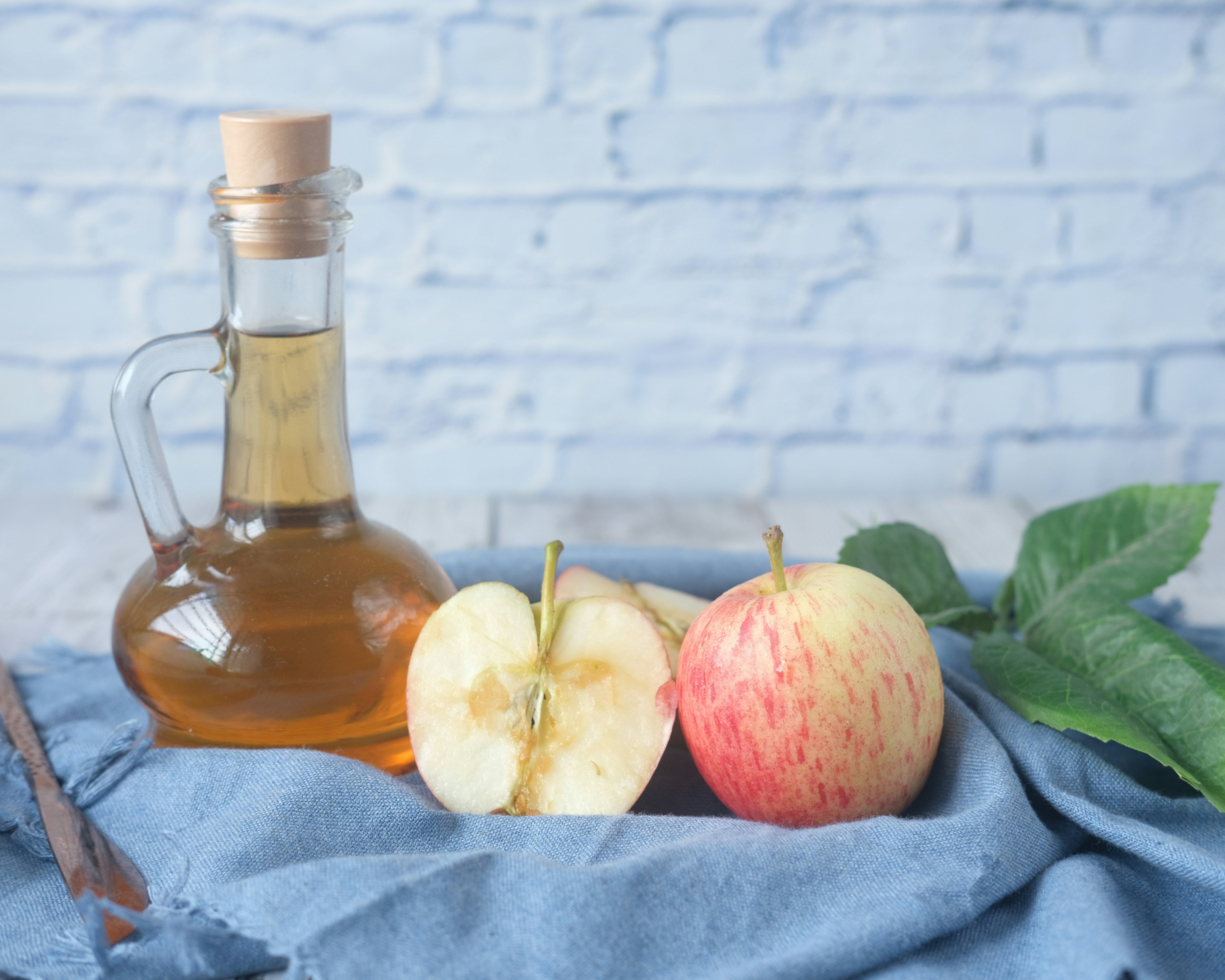 Apple Cider Vinegar beside a few apples