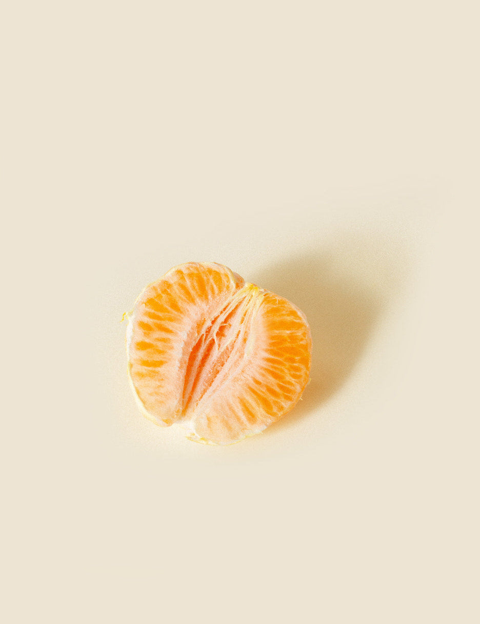 half of an orange, meant to represent the female genitalia